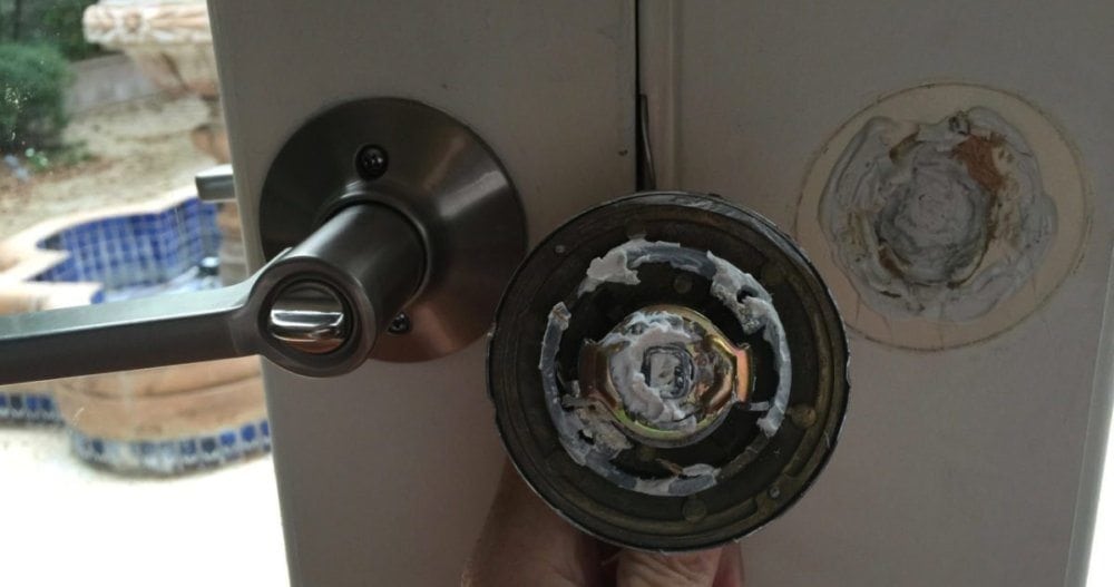 House flippers were either too lazy or too stupid to screw the other door handle into the door. Instead they used caulking and when that didn't work, they scotch taped the door knob to the door.