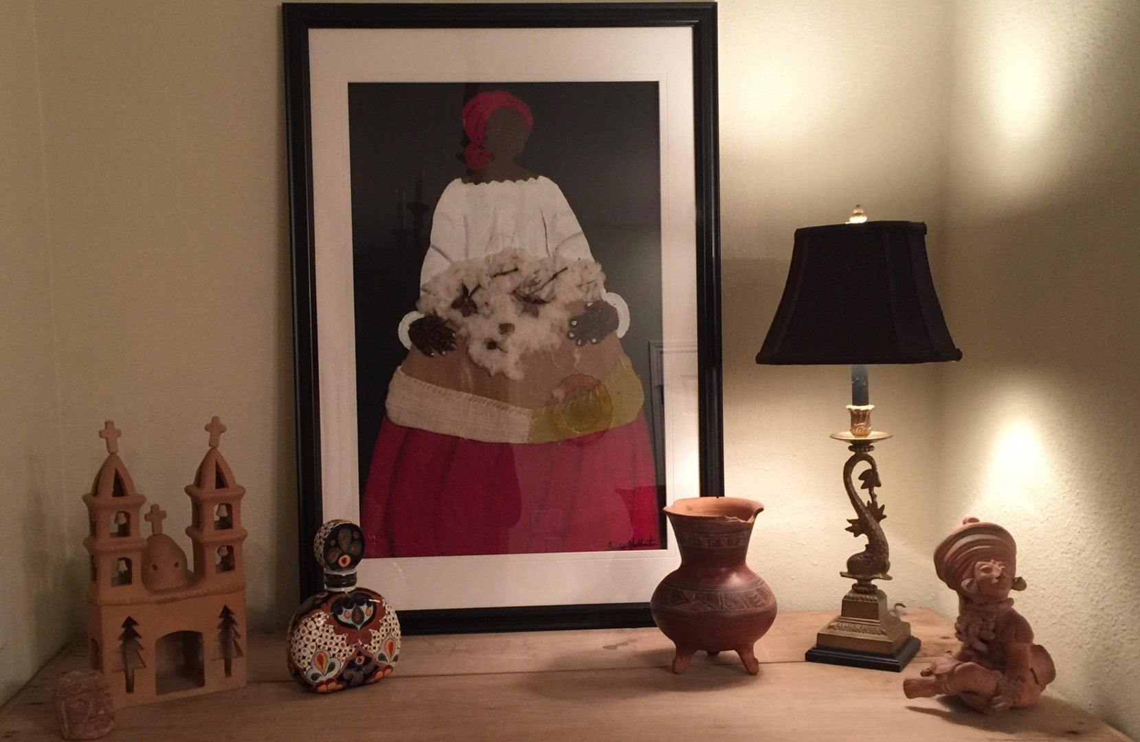 So many things from my life are reflected in this house: when I dug for Mayan artifacts and my love for folk art. This framed, mixed media piece is by Jackie Haliburton.