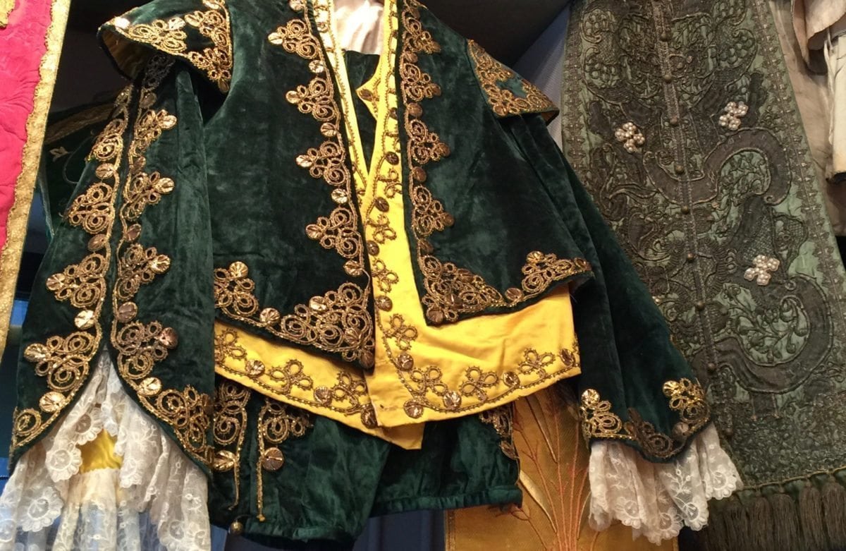 Left: Man's velvet jacket, silk vest and lace shirt. Right: Priest's velvet and pearl vestment.