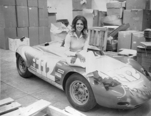 I'm 22 years old in this photo and sitting on a vintage Porsche RSK Spyder race car in need of a paint job.